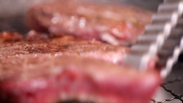 Juicy grilled steaks cooked over a charcoal grill