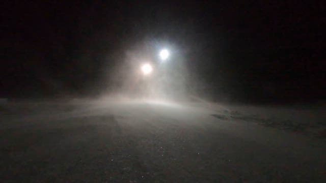 Heavy Snowfall and Bright Lights at Night