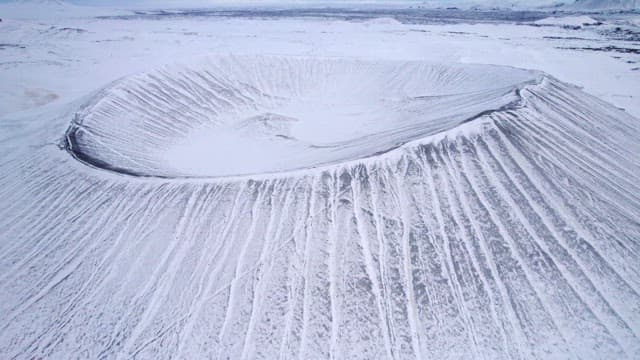 Snow-covered volcanic crater in winter