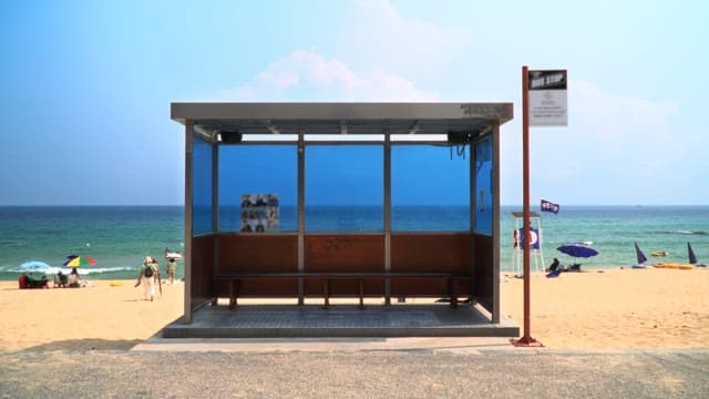 Bus stop by the beach with a clear sky