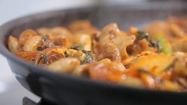 Stir-fried gopchang with vegetables on a hot plate