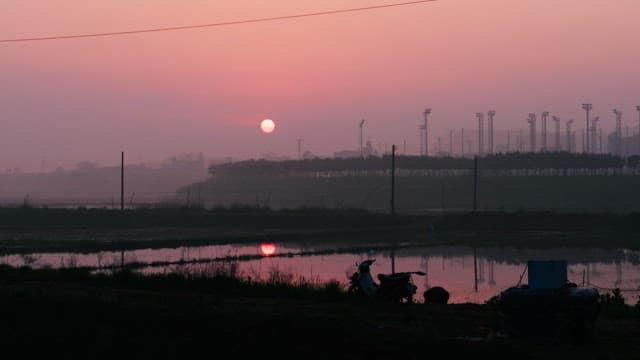 Sunrise over the Tranquil lakeside with Silhouettes