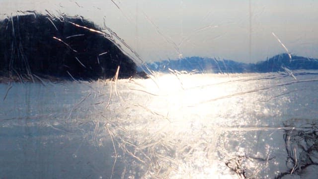 Serene seascape seen through the window of a tent in the early morning