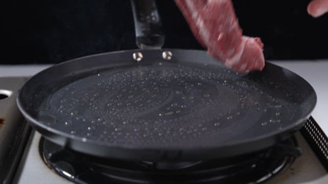 Sizzling Steak in a Hot Frying Pan