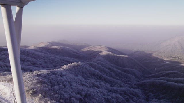 Wind Generators on Misty and Snowy Mountain in the Morning