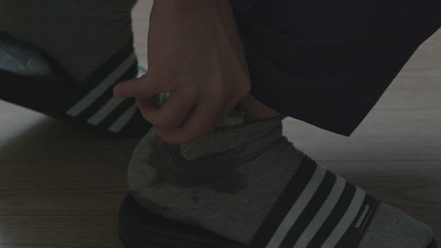 Person taking out money hidden in a sock