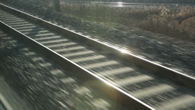 Gravel railway tracks with sunlight