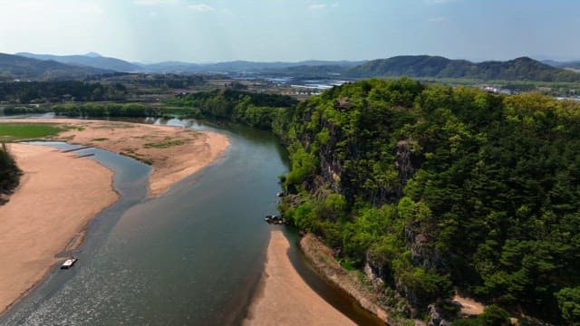 Serene river flowing beside rocky cliffs
