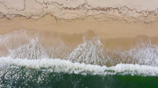 Waves Crashing on a Serene Sandy Beach