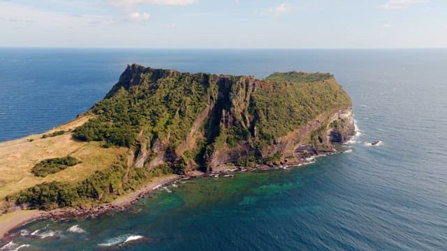 Scenic island with lush greenery and ocean