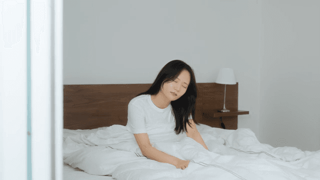 Woman Waking Up in Bed