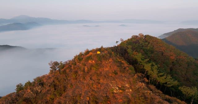 Sky Colored by Sunrise over Foggy Mountains