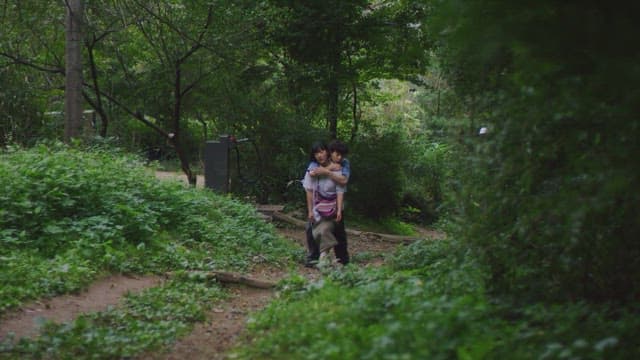 Couple walking along a forest path, talking