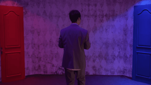 Man in a suit choosing between two doors