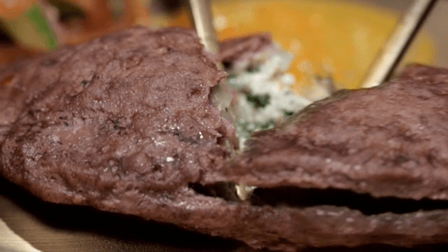 Cutting through deliciously grilled meat dumplings with chopsticks
