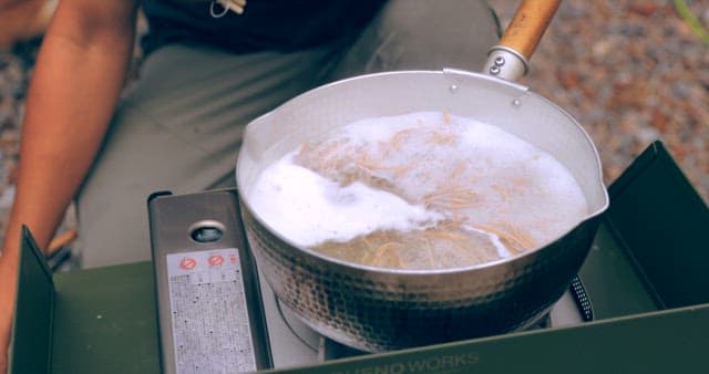 Preparing noodles in an outdoor setting