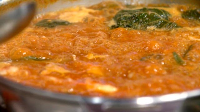 Napa cabbage and pork backbone stew boiling in a pot