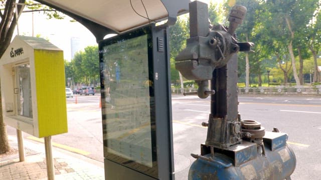 Bus stop with a map and old machinery