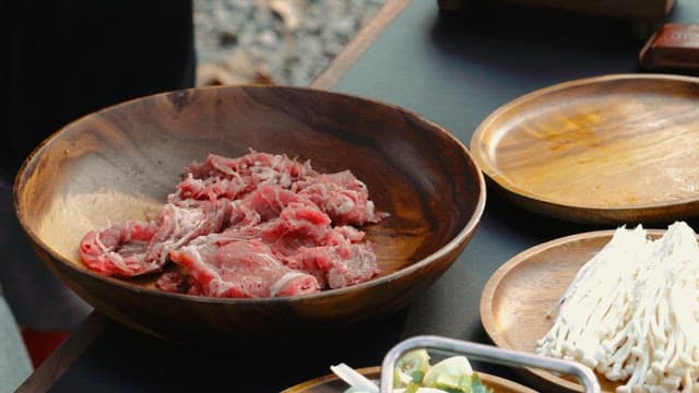 Seasoning Beef in a Wooden Bowl for Cooking