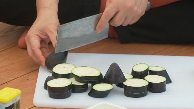 Slicing eggplants on a cutting board