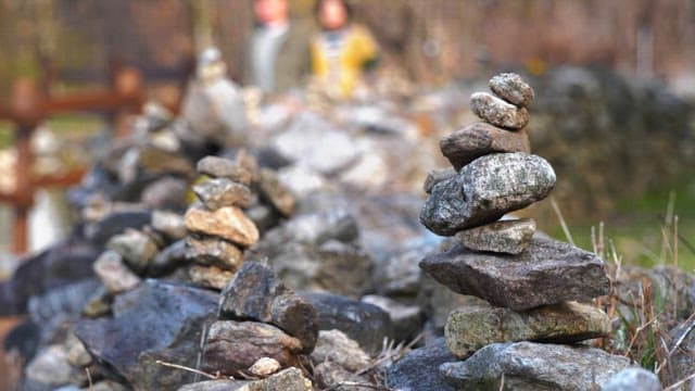 Small rock formation by a walking trail on a sunny day