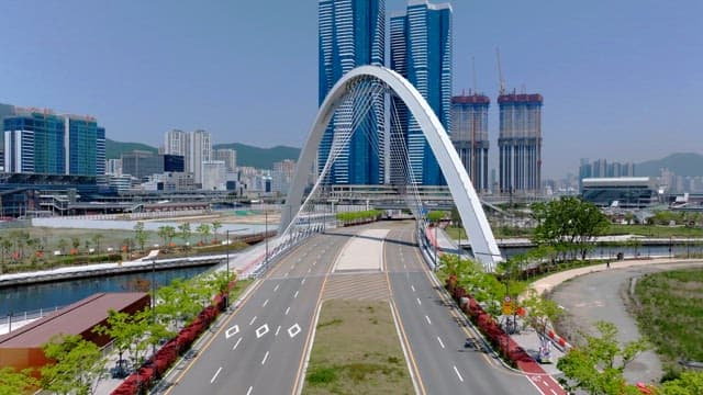 Modern urban arch architecture with skyscrapers in the background on a clear day