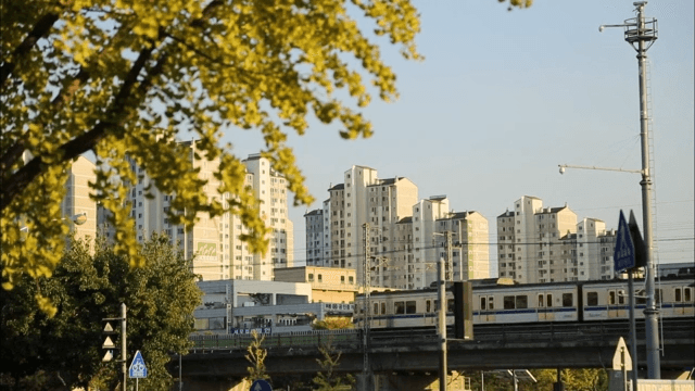 Subway passing above ground near apartment