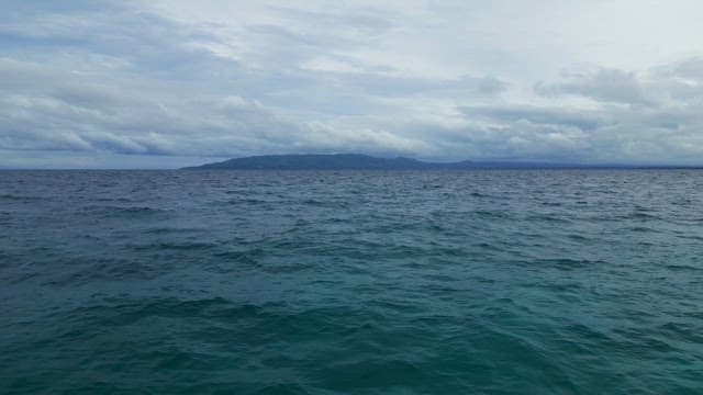 Calm ocean with distant mountains