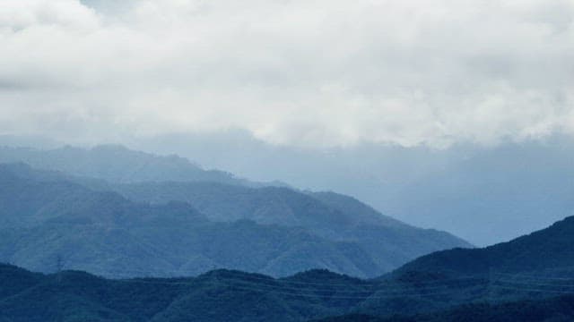 Cloudy mountain landscape with mist