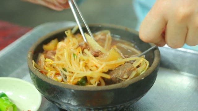 Beef and rice soup in an earthen pot