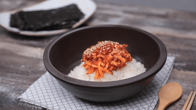 Rice topped with spicy sweet potato salad in a bowl