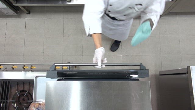 Chef preparing garlic toast in kitchen oven