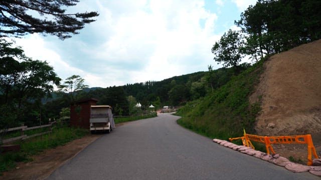 Scenic walking path in a green area overlooking the mountains