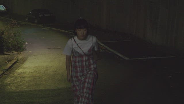 Woman walking alone at night on an empty street