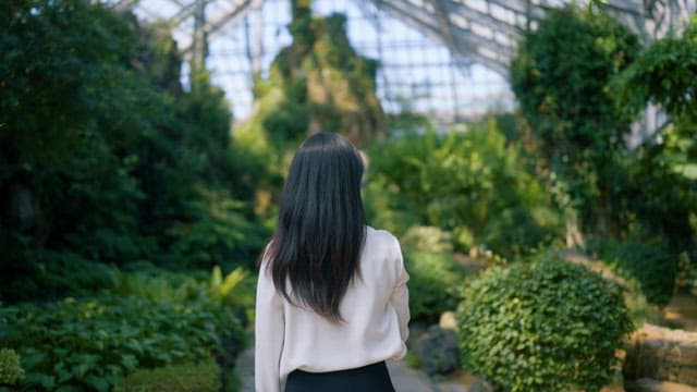 Woman Contemplating in Lush Garden