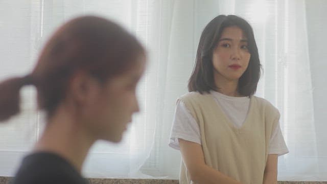 Two women in a softly sunlit room