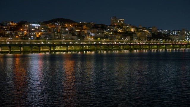 Nighttime View of Illuminated Cityscape Across the Water