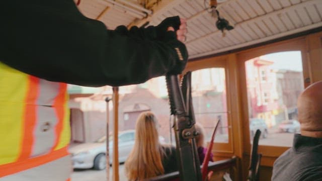 Driver Controlling a Tram Passing Through the City