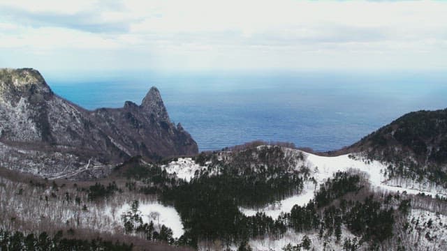 Snowy Coastal Cliffs Overlooking the Ocean