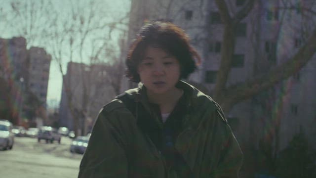 Woman walking in front of apartment with a depressed expression in the morning