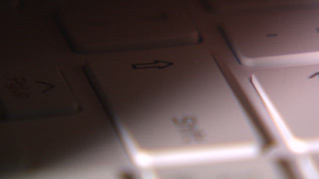 Finger pressing delete button on keyboard