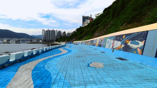 Coastal city walkway with mosaic art
