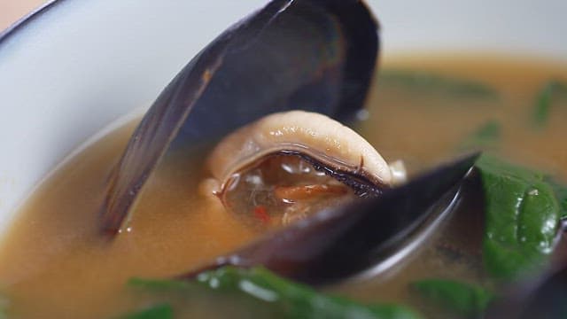 Seafood soup with a rich broth filled with fresh vegetables and mussels