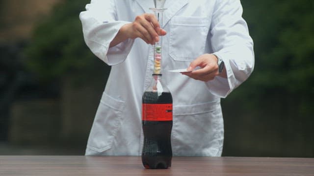Outdoor science experiment with soda and candies