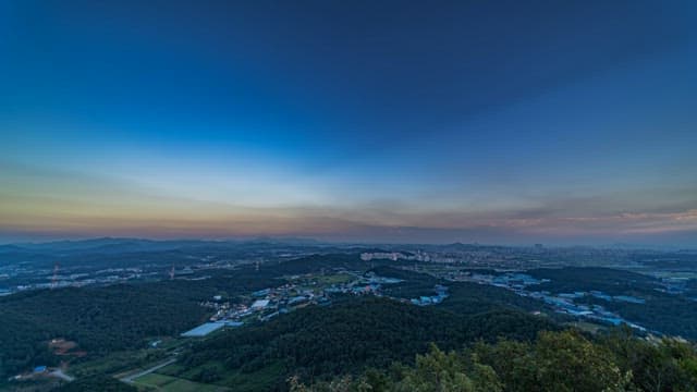 Sky Turning into Dusk over the Mountains and City