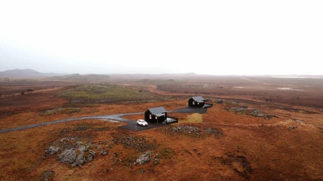 Remote cabins in a vast open landscape