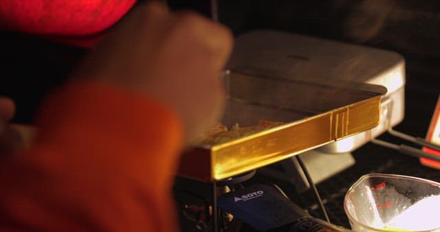 Cooking a meal on a portable stove