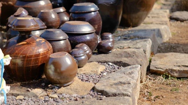 Traditional Pots, Earthenwares on a Stone-Paved Ground under the Sun
