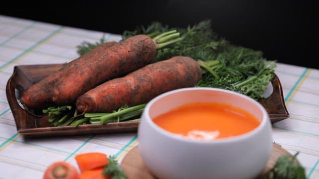 Dirted carrots and carrot podrridge on a table