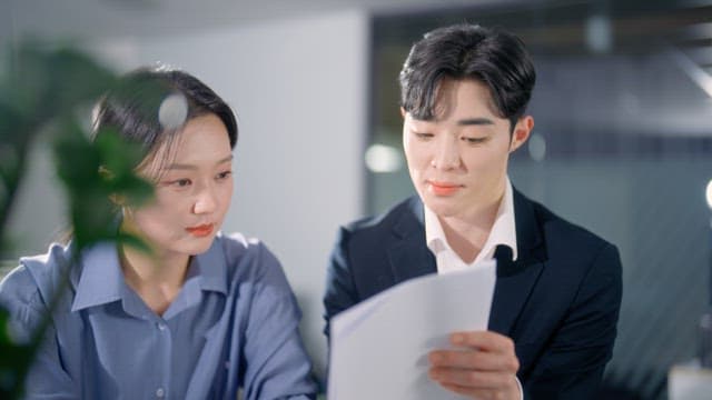 Two colleagues discussing documents